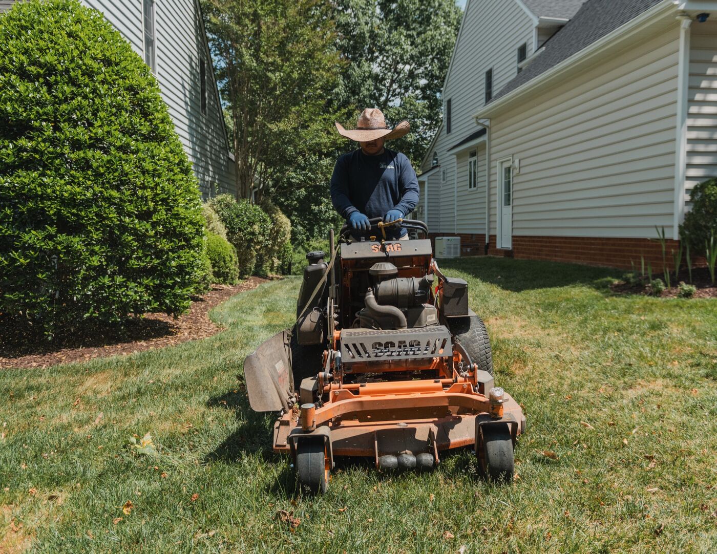 Crew mowing on a stand-on mower